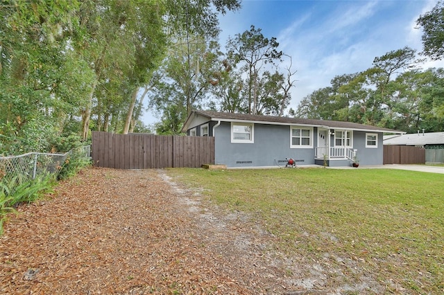 ranch-style house with covered porch and a front lawn