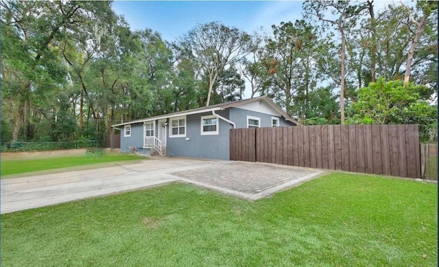 rear view of property with a lawn