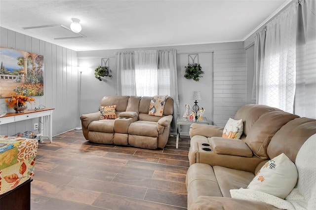 living room with dark hardwood / wood-style floors and wood walls