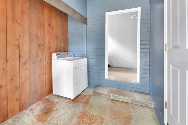 laundry area featuring washer / clothes dryer and wooden walls