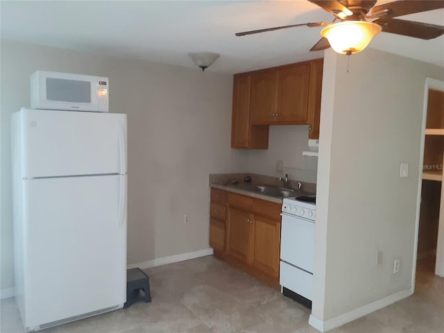 kitchen featuring white appliances, ceiling fan, and sink