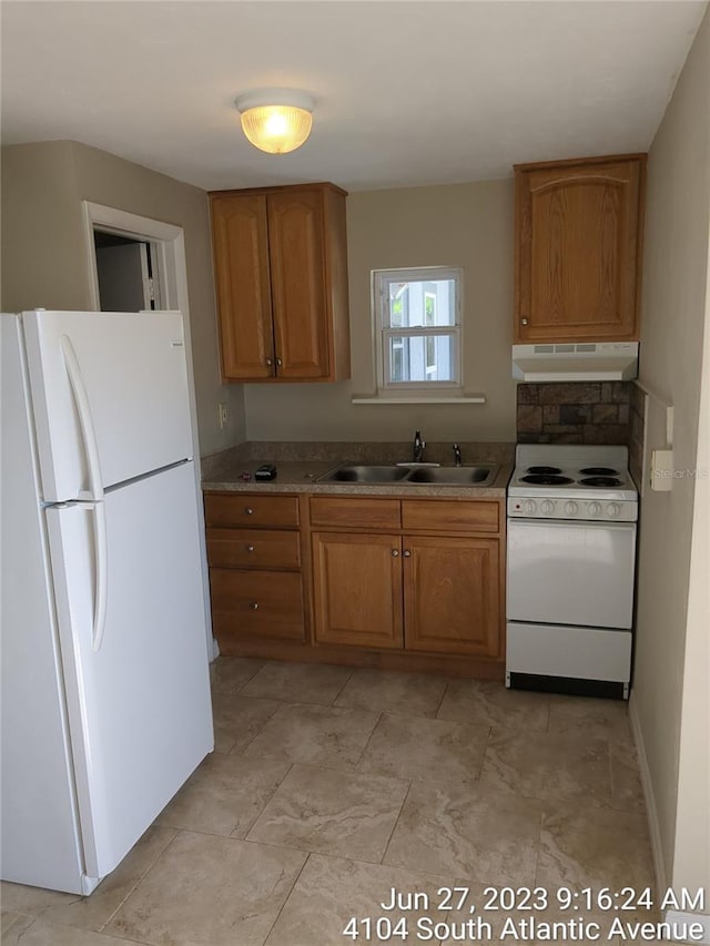 kitchen with white appliances and sink