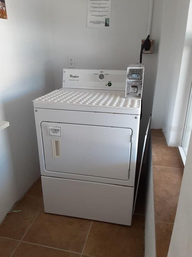 clothes washing area featuring washer / clothes dryer and tile patterned floors