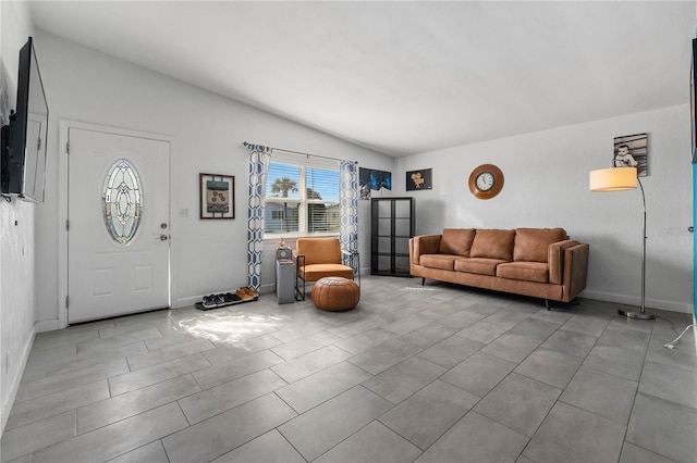 tiled living room featuring vaulted ceiling