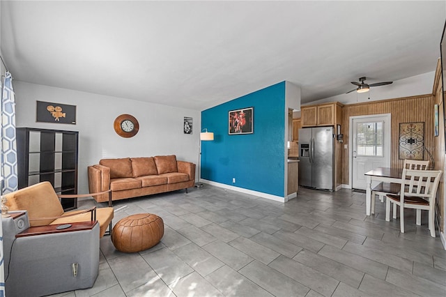 living room with ceiling fan and vaulted ceiling