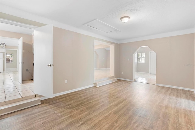 unfurnished room featuring light wood-type flooring and ornamental molding