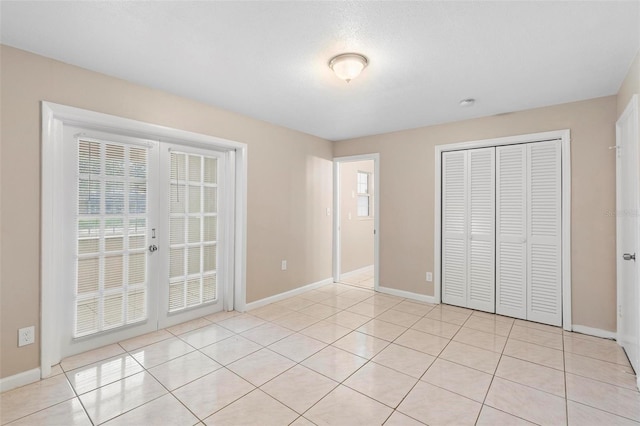 unfurnished bedroom featuring a closet and light tile patterned floors