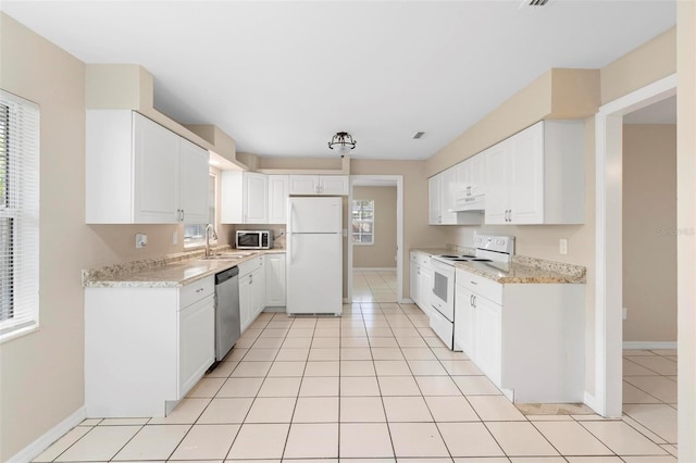 kitchen with white cabinets, a healthy amount of sunlight, and appliances with stainless steel finishes