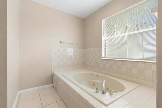 bathroom featuring tiled tub, a wealth of natural light, and tile patterned flooring