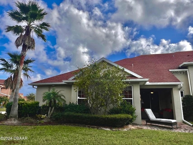 back of property featuring a lawn