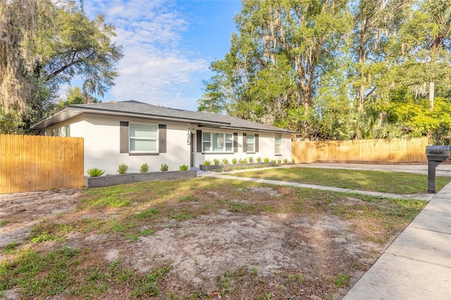 ranch-style home featuring a front yard