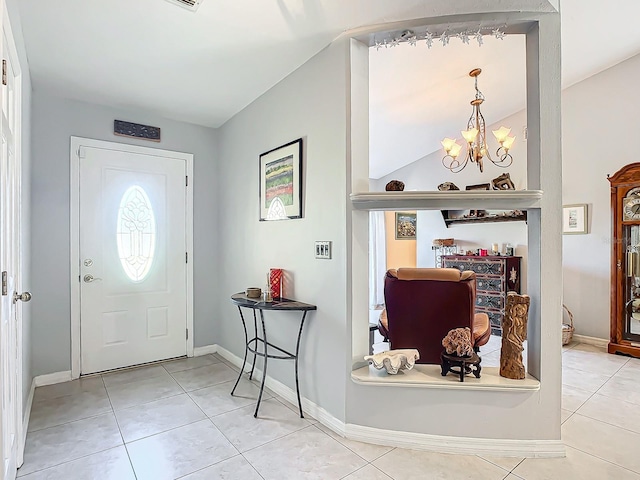 foyer entrance featuring light tile patterned floors and an inviting chandelier