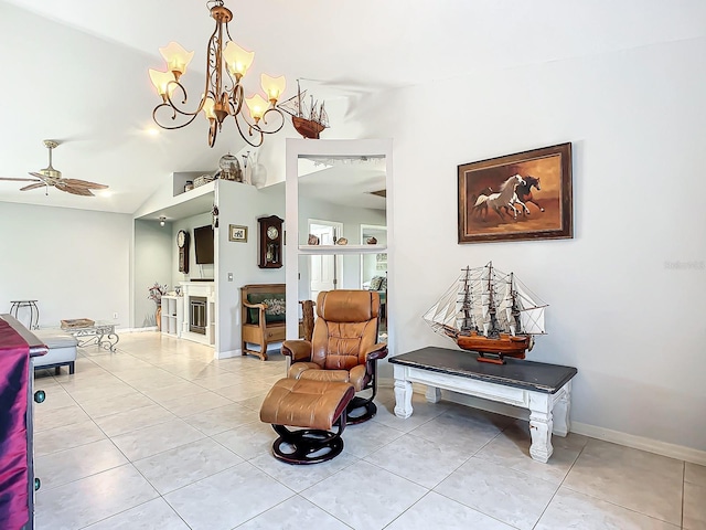 sitting room featuring ceiling fan with notable chandelier, lofted ceiling, and light tile patterned floors