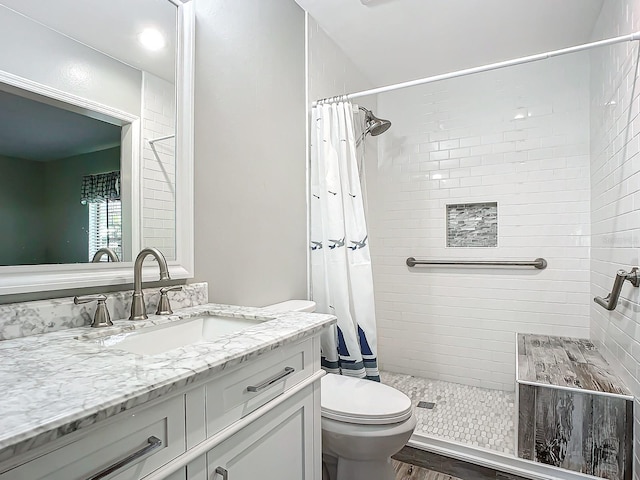 bathroom featuring hardwood / wood-style floors, vanity, toilet, and a shower with curtain