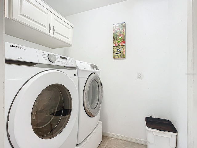 washroom with cabinets, light tile patterned floors, and separate washer and dryer