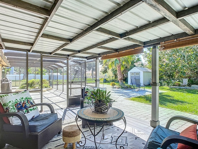 deck with a yard, an outdoor living space, a patio, and a storage shed