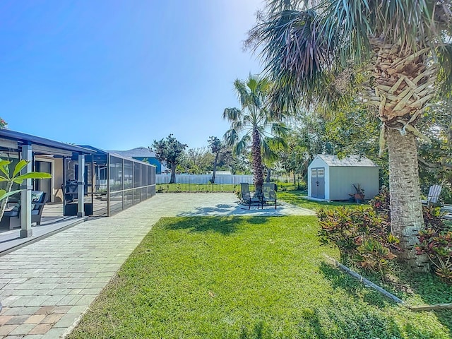 view of yard with a patio and a storage unit