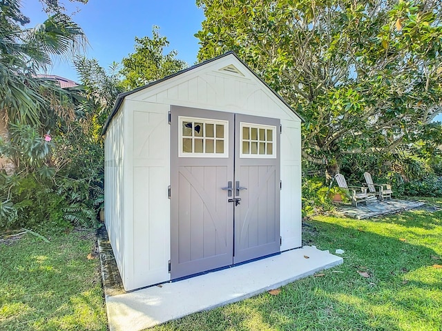 view of outbuilding with a lawn