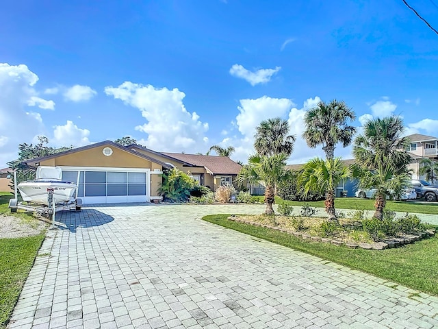 view of front facade featuring a front yard and a garage