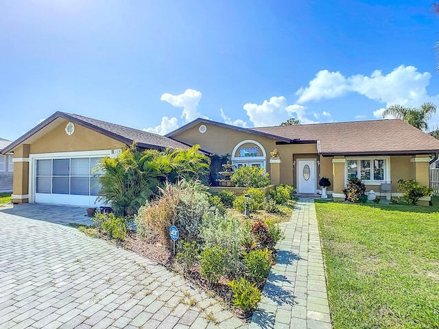 single story home featuring a garage and a front lawn