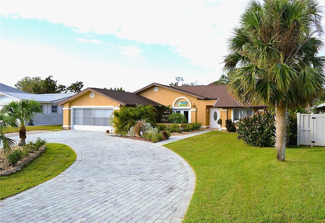 single story home featuring a garage and a front lawn