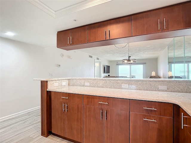 kitchen with pendant lighting, ornamental molding, a notable chandelier, light hardwood / wood-style floors, and kitchen peninsula