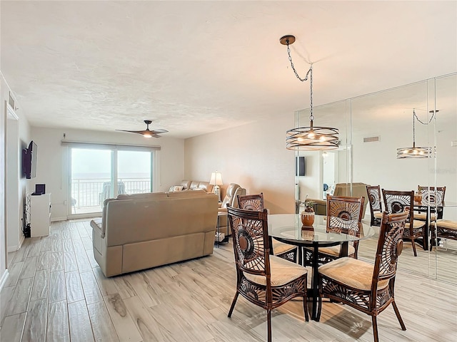 dining space featuring ceiling fan and light hardwood / wood-style flooring