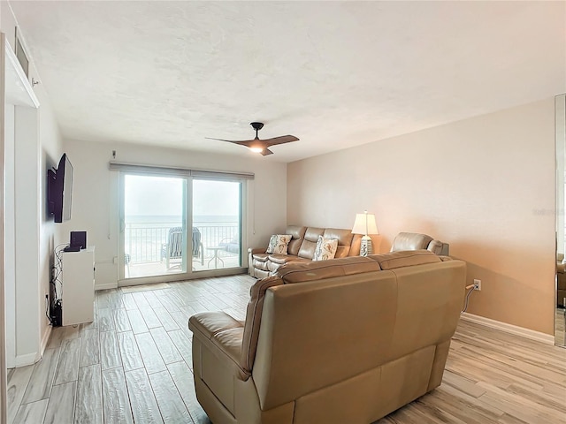 living room with ceiling fan and light hardwood / wood-style floors