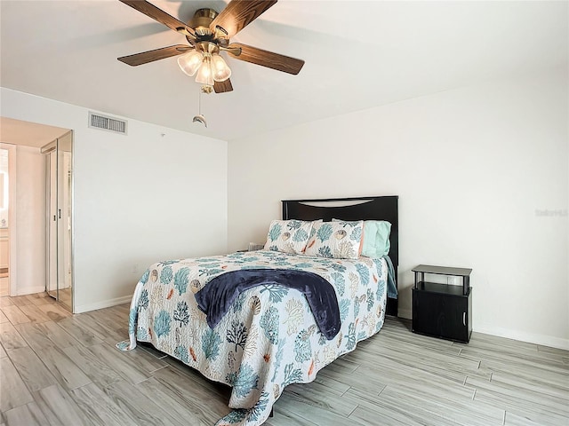 bedroom with ceiling fan and light hardwood / wood-style flooring