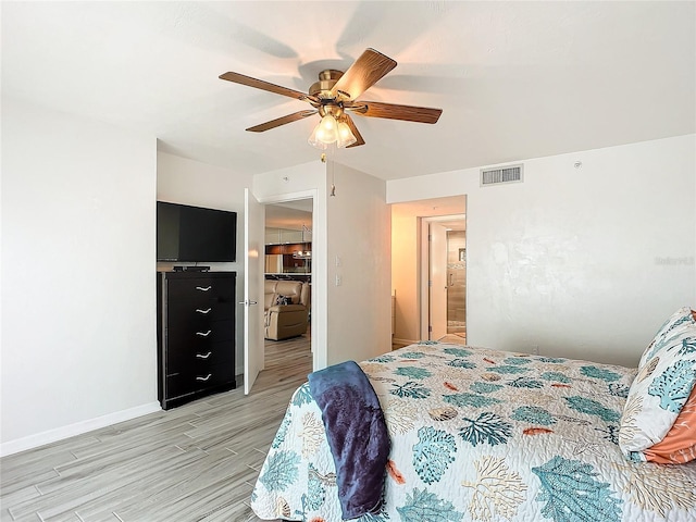 bedroom with ceiling fan and light hardwood / wood-style flooring