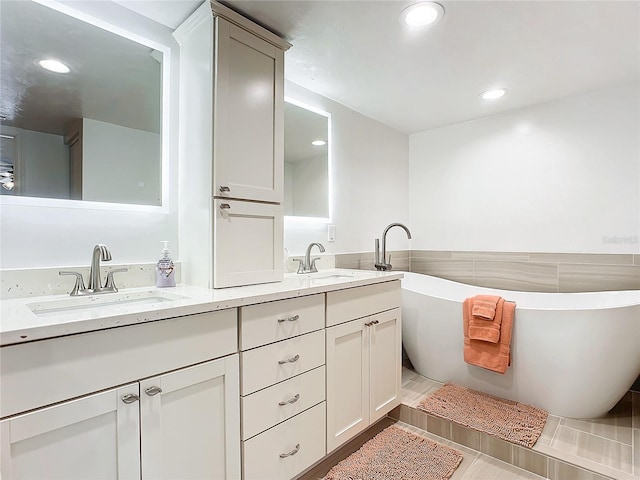 bathroom featuring a tub and vanity