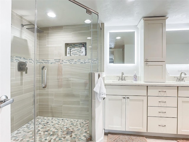 bathroom featuring vanity and an enclosed shower