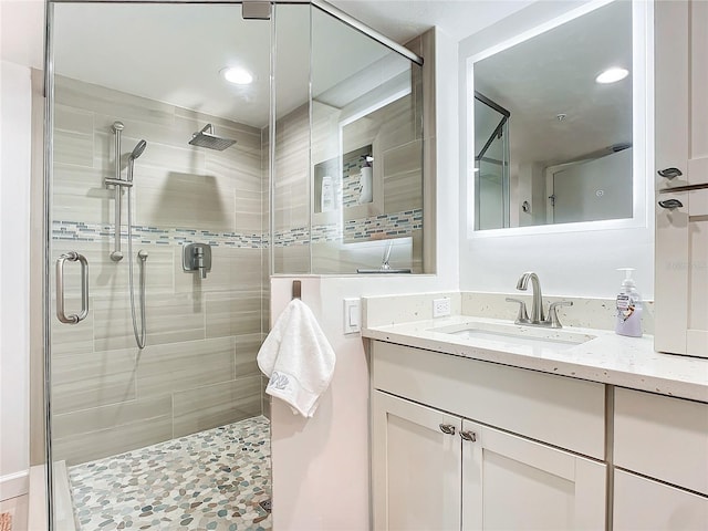 bathroom with vanity and a shower with shower door