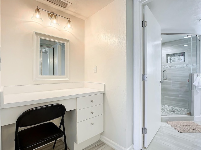 bathroom featuring hardwood / wood-style floors, vanity, and walk in shower