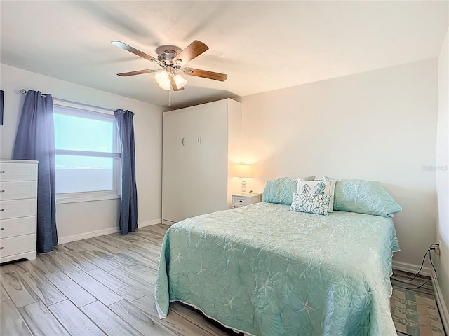 bedroom featuring ceiling fan and light hardwood / wood-style flooring