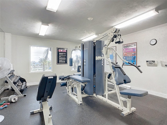 exercise room with a textured ceiling