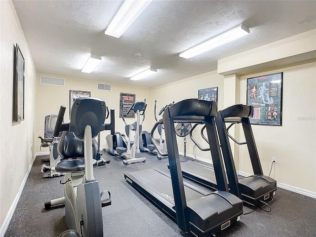 workout area with a textured ceiling