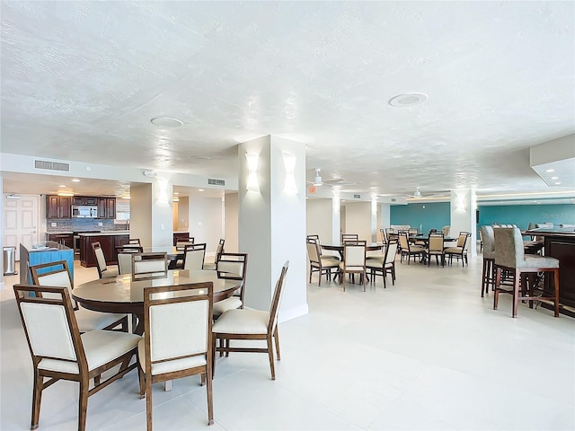 dining area featuring a textured ceiling