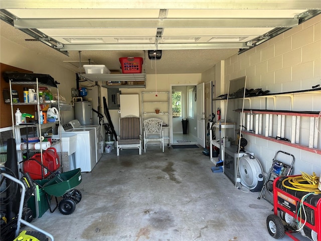 garage with independent washer and dryer, gas water heater, and a garage door opener