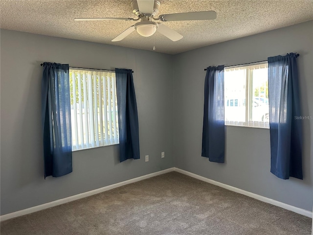 spare room featuring ceiling fan, carpet floors, and a textured ceiling