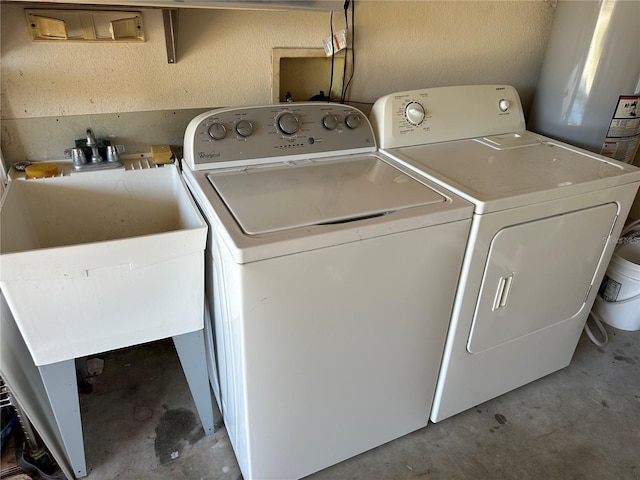 laundry room with washer and dryer and gas water heater