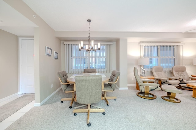 dining area with light colored carpet and an inviting chandelier