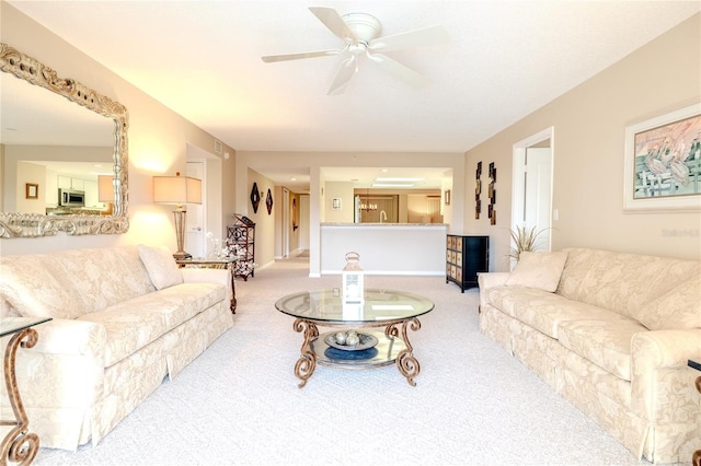 living room with ceiling fan and light carpet