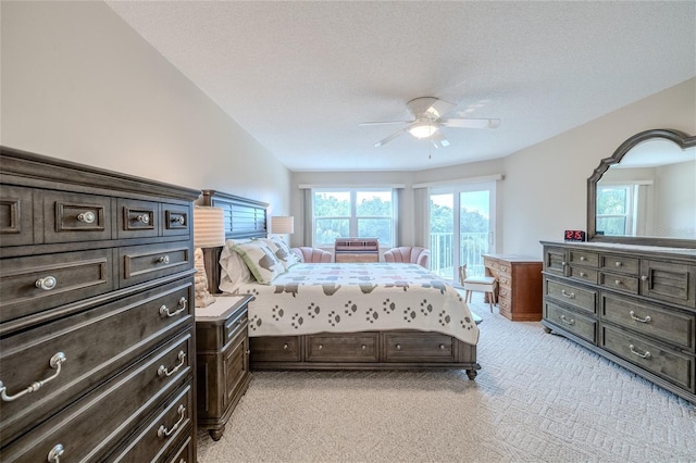 bedroom with a textured ceiling, ceiling fan, lofted ceiling, and light carpet