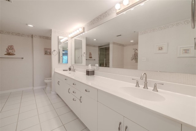 bathroom with tile patterned floors, vanity, toilet, and an enclosed shower