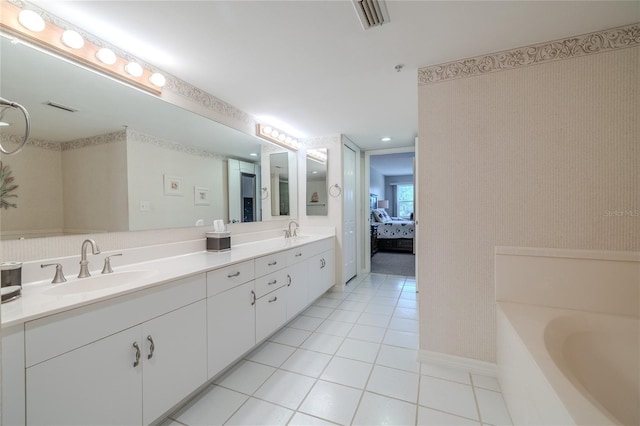 bathroom with vanity, tile patterned floors, and a tub