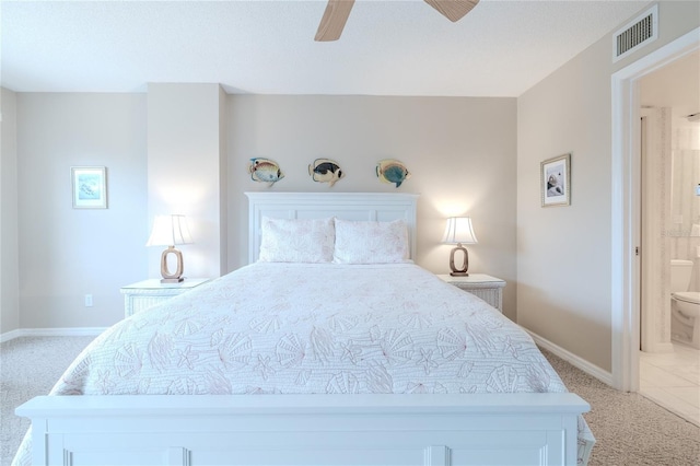 bedroom featuring ensuite bathroom, ceiling fan, and light carpet