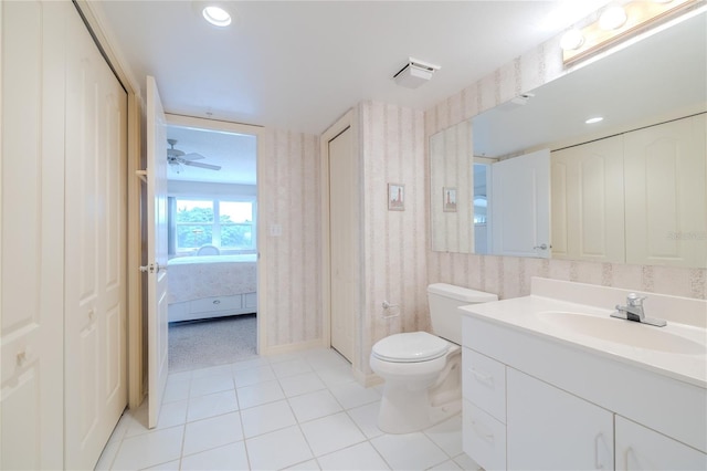 bathroom with tile patterned floors, ceiling fan, toilet, and vanity