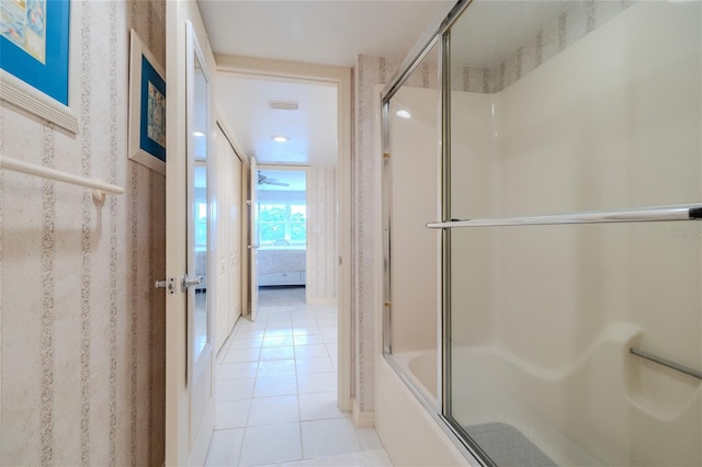 bathroom featuring tile patterned flooring and bath / shower combo with glass door