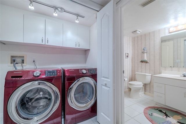 laundry area featuring light tile patterned flooring and washing machine and clothes dryer